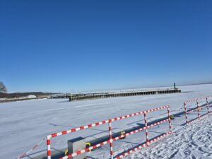 Zamarznięty zalew wiślany od strony Krynicy Morskiej. Zamarznięta tafla wody. Jasne niebo w ciągu zimowego dnia. 